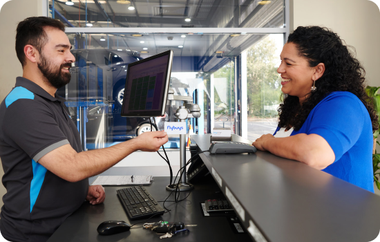 mycar staff handing Flybuys card back to customer.